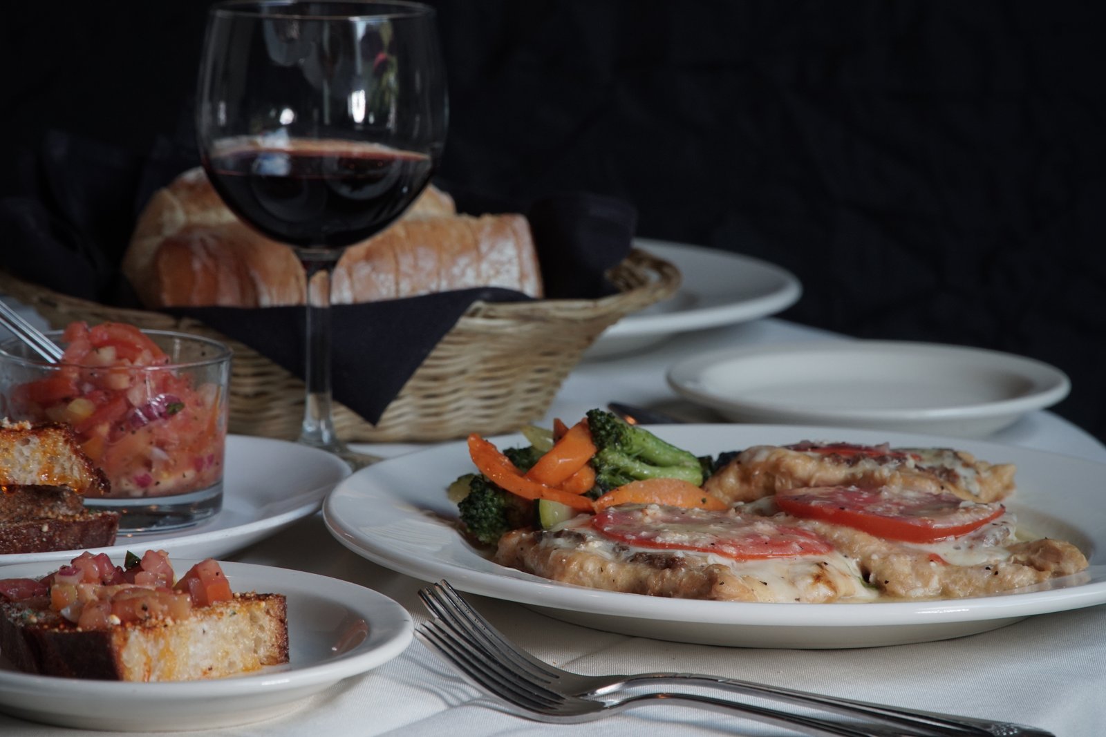 Chicken topped with fresh mozzarella and tomato